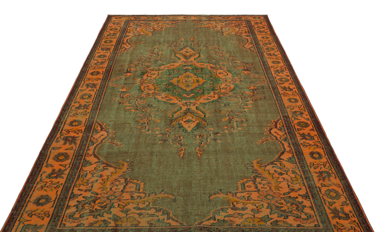 Olive green and orange traditional rug with a central medallion and ornate border pattern on a white background.