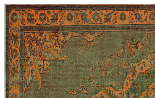 Load image 1 in gallery view. Olive green and burnt orange traditional rug with a distressed floral border and central medallion pattern.