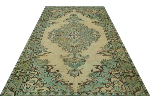 Load image 1 in gallery view. Sage green and beige vintage-style rug with a central floral medallion and ornate border on a white background.