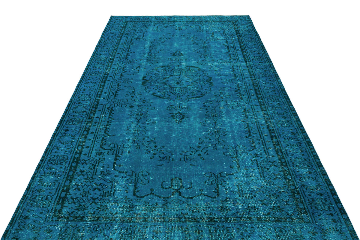 Teal distressed area rug with a traditional central medallion and ornate border pattern on a white background.