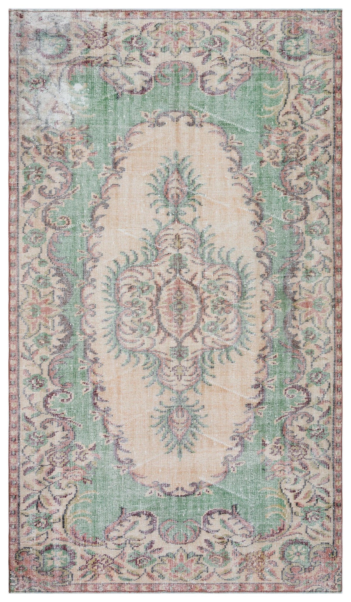 Distressed sage green and peach vintage-style rug with a central floral medallion and ornate border.