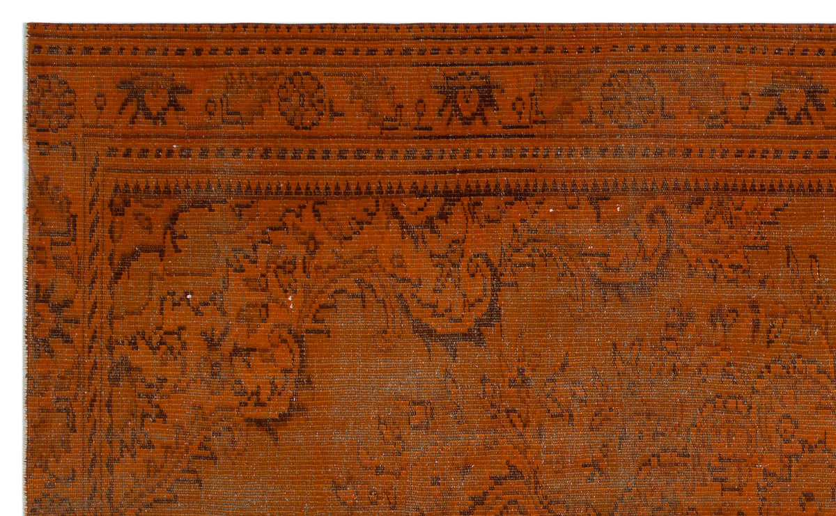 Rust-colored rug with a dark brown traditional floral border and intricate, distressed medallion pattern.
