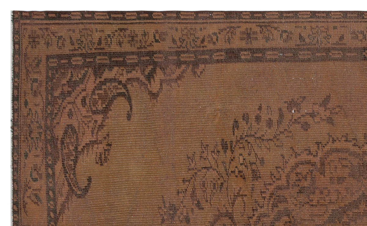 Brown traditional rug with a dark brown ornate floral border and central paisley-inspired motif.