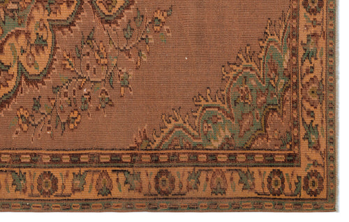 Load image 1 in gallery view. Brown traditional rug with green and tan floral motifs and a geometric border pattern.