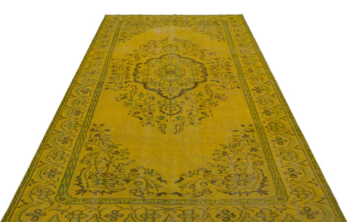 Load image 1 in gallery view. Mustard yellow vintage-style rug with a central dark floral medallion and intricate border pattern.