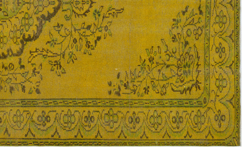 Load image 1 in gallery view. Mustard yellow rug with a distressed floral pattern and a geometric border in olive green and dark brown.