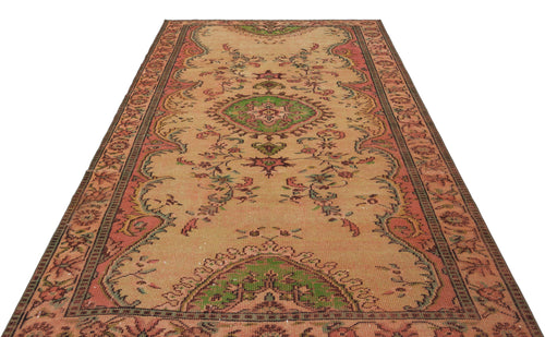 Load image 1 in gallery view. Tan vintage-style runner rug with a central green medallion, floral motifs, and a coral border on a white background.