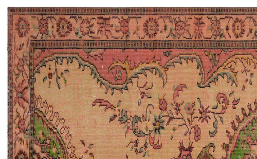 Load image 1 in gallery view. Salmon, green, and tan traditional rug with a floral medallion pattern and ornate decorative border.