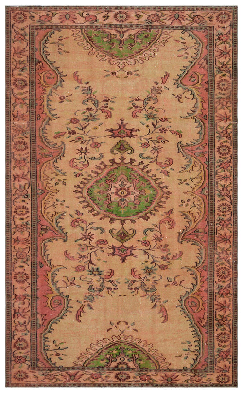 Load image 1 in gallery view. Tan vintage-style rug with a central green floral medallion, pink borders, and intricate botanical motifs.