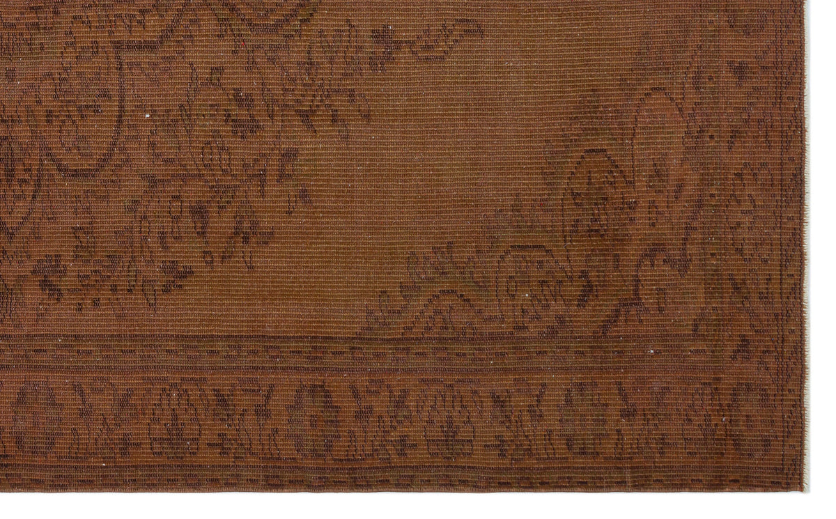 Monochromatic rust-brown rug with a subtle, low-contrast floral medallion pattern and a detailed border.