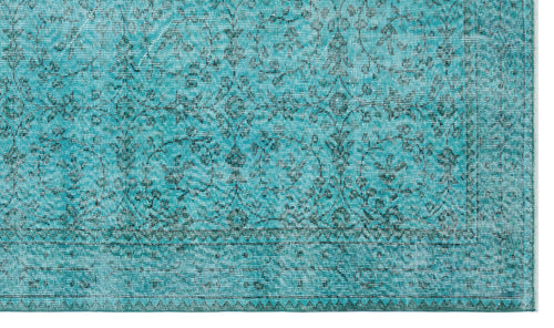 Load image 1 in gallery view. Teal rug with a distressed traditional floral pattern and a geometric border on a white background.