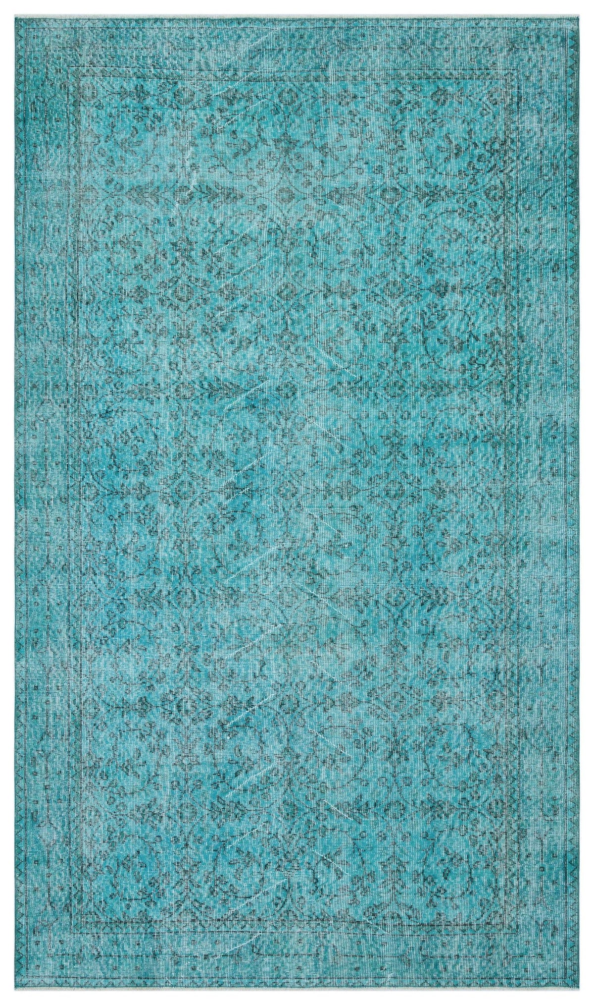 Teal distressed area rug with a traditional floral medallion pattern and a bordered edge.