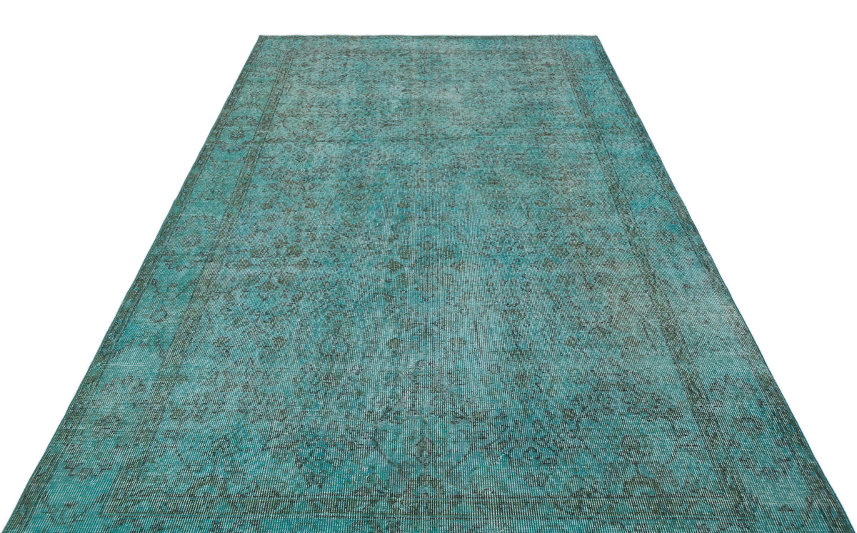 Teal and dark grey distressed rug with a traditional ornate medallion pattern on a white background.