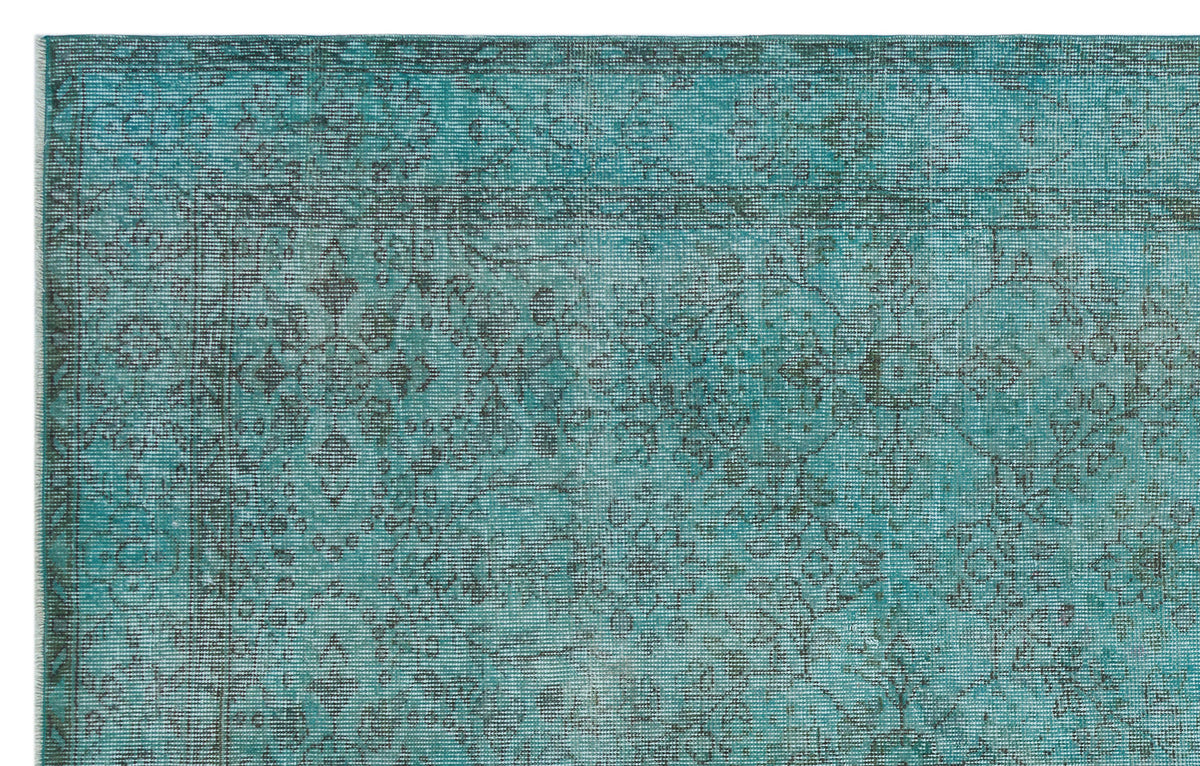 Teal and charcoal distressed rug with a traditional floral medallion pattern and a detailed border.
