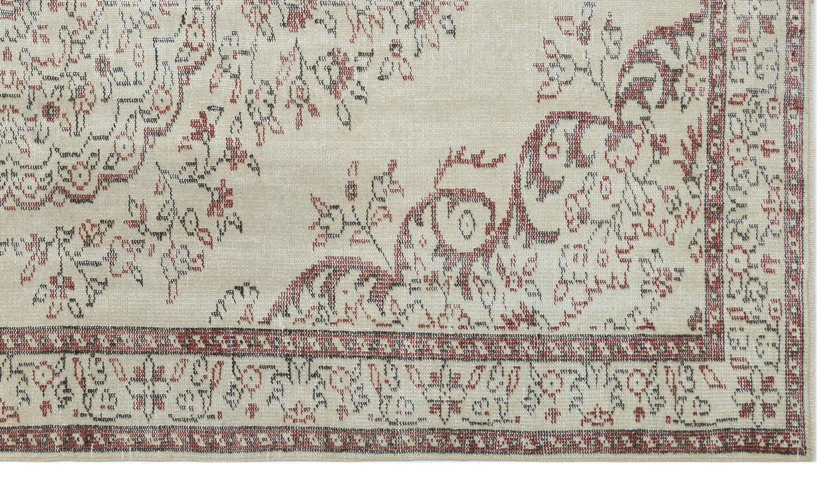 Beige rug with a distressed red and charcoal floral medallion pattern and a decorative border.