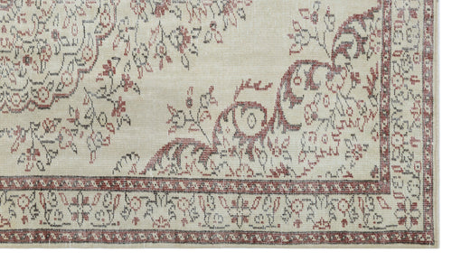 Load image 1 in gallery view. Beige rug with a distressed red and charcoal floral medallion pattern and a decorative border.