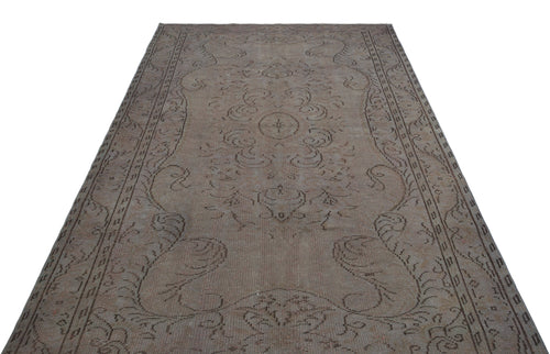 Load image 1 in gallery view. Faded taupe and brown vintage rug with a central floral medallion and ornate border on a white background.