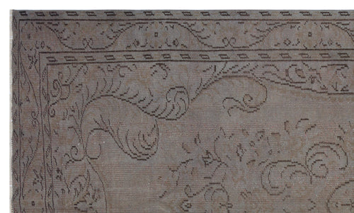Load image 1 in gallery view. Taupe vintage-style rug with a dark brown linear floral motif and a geometric border.