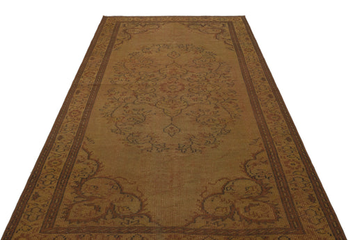 Load image 1 in gallery view. Brown vintage-style rug with a central floral medallion and ornate border pattern on a white background.