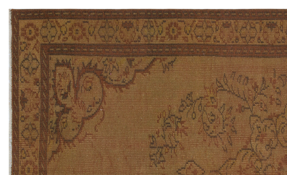 Brown and rust-colored traditional rug with a floral medallion border and intricate botanical motifs.