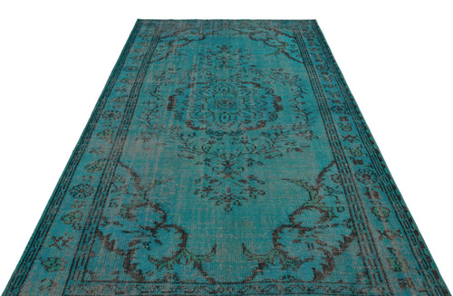 Load image 1 in gallery view. Distressed teal and charcoal vintage-style rug with a central floral medallion and ornate border on a white background.