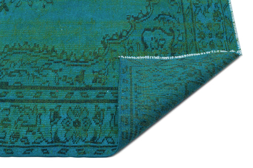 Load image 1 in gallery view. Teal and dark green traditional rug with a floral medallion pattern, shown with a folded corner on a white background.