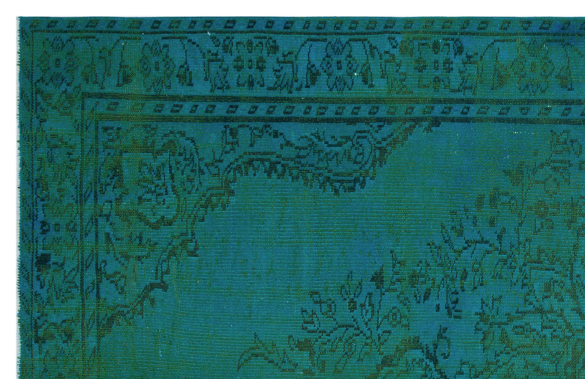 Teal and dark green traditional rug with a distressed floral medallion pattern and a decorative border.
