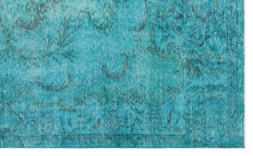 Load image 1 in gallery view. Turquoise rug with a distressed, faded floral medallion pattern and a visible border.