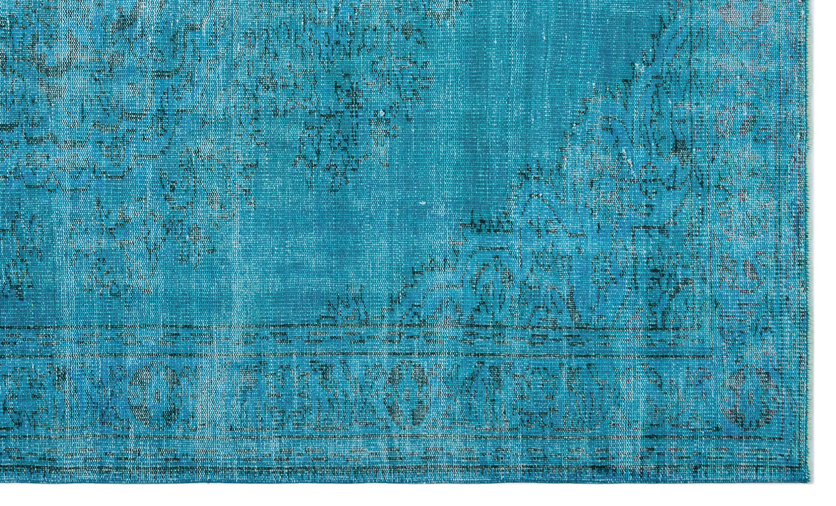 Bright turquoise rug with a distressed, faded traditional medallion pattern and a bordered edge.