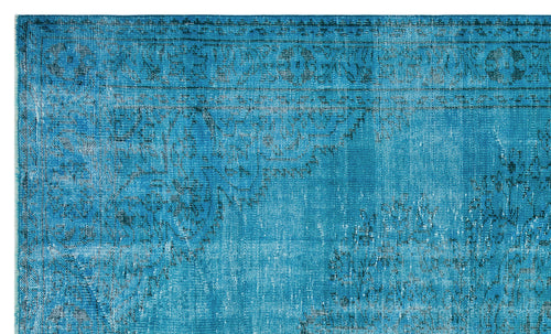 Load image 1 in gallery view. Bright blue distressed rug with a faded black traditional medallion and border pattern.