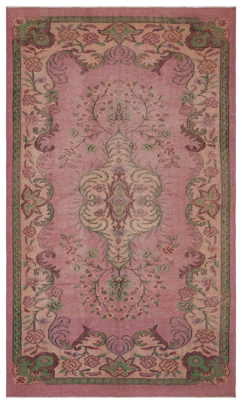 Load image 1 in gallery view. Dusty rose vintage-style rug with a central floral medallion and a decorative border in muted green and brown tones.