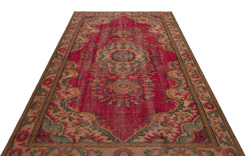 Load image 1 in gallery view. Red vintage-style rug with a central floral medallion, intricate border, and distressed green and beige accents.