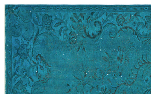 Load image 1 in gallery view. Teal rug with a dark blue distressed floral pattern and a decorative border.