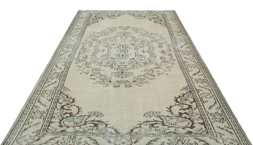 Load image 1 in gallery view. Beige and charcoal distressed traditional rug with a central floral medallion and ornate border pattern.