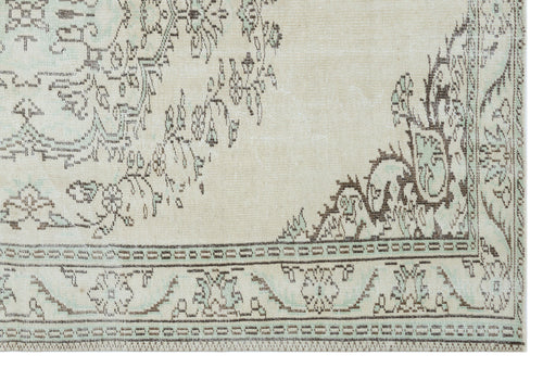 Load image 1 in gallery view. Cream and light blue rug with a distressed brown floral medallion pattern and geometric border.
