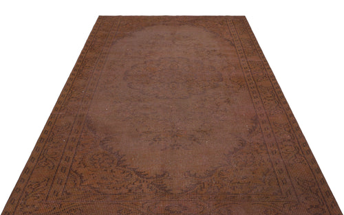 Load image 1 in gallery view. Monochromatic brown rug with a faint, traditional central medallion and ornate border pattern on a white background.