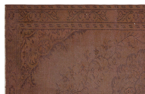 Load image 1 in gallery view. Dark brown rug with a subtle, tonal floral border and central medallion pattern.