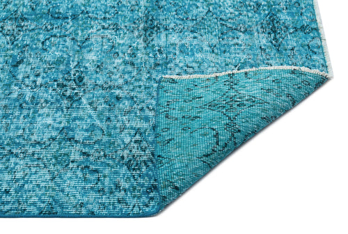 Load image 1 in gallery view. Teal distressed rug with a faded traditional medallion pattern and a folded corner showing the woven backing.