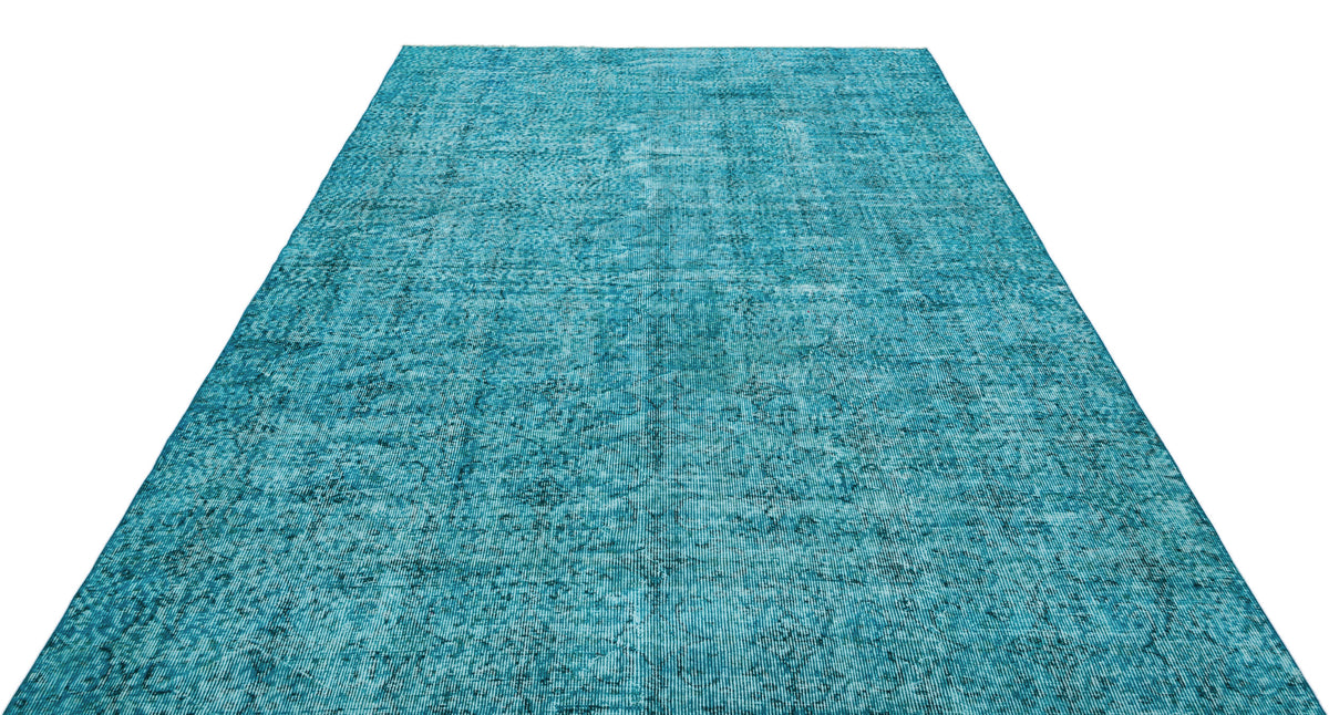 Teal rectangular rug with a distressed, faded traditional medallion pattern on a white background.