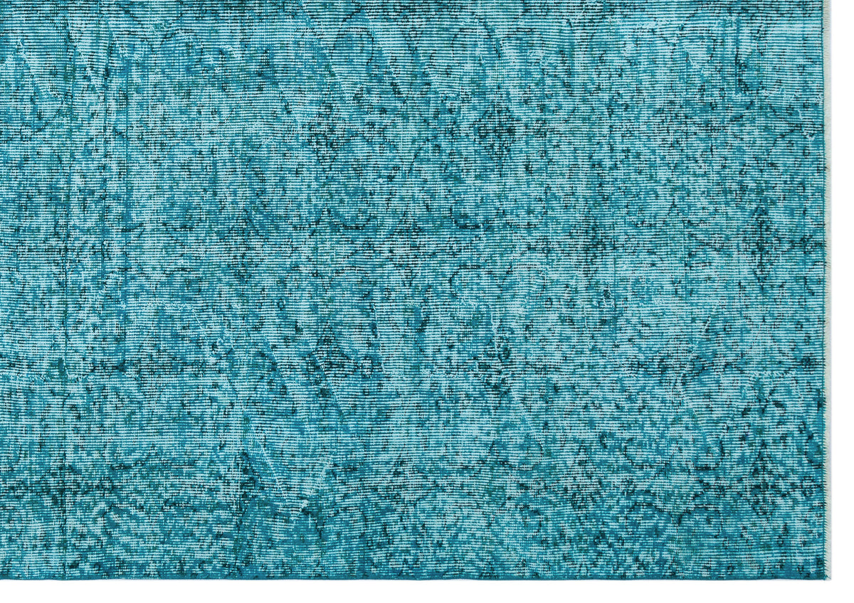 Teal and dark blue distressed rug with a faded traditional medallion pattern.