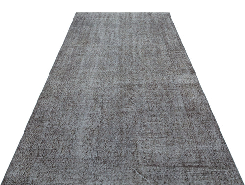 Load image 1 in gallery view. Grey and charcoal distressed runner rug with a faded traditional medallion pattern on a white background.