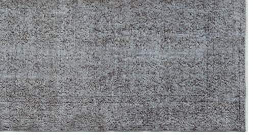 Load image 1 in gallery view. Grey and charcoal distressed rug with a faded traditional floral pattern on a white background.