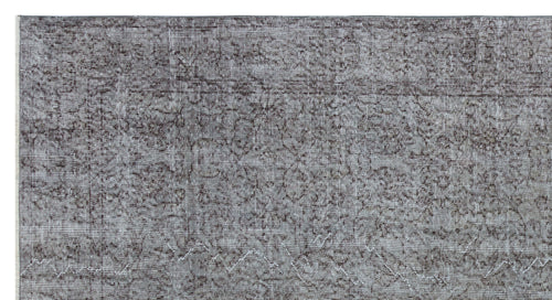 Load image 1 in gallery view. Grey and charcoal distressed rug with a traditional floral medallion pattern.