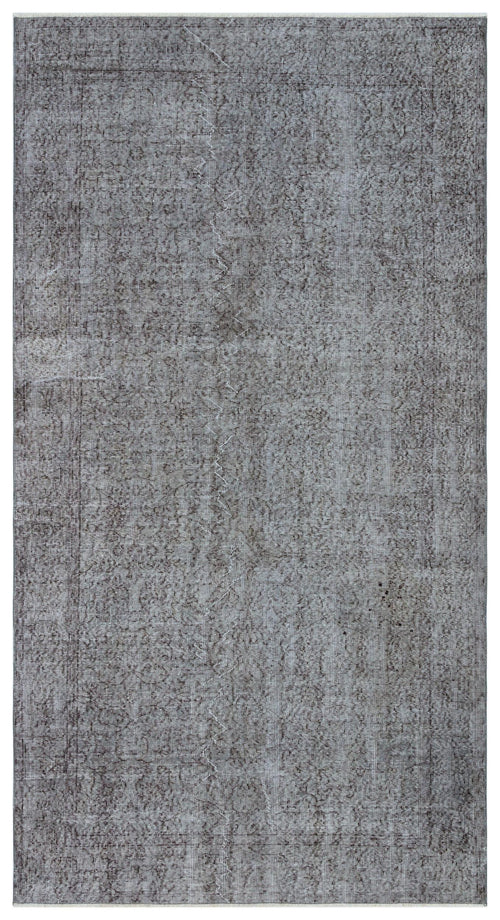 Load image 1 in gallery view. Charcoal grey distressed rug with a faint, traditional overdyed medallion pattern.