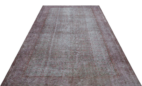 Load image 1 in gallery view. Faded mauve and grey vintage-style rug with a distressed floral medallion pattern and a wide border.