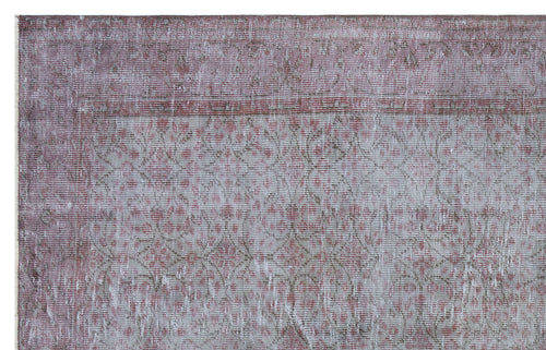 Load image 1 in gallery view. Distressed mauve and grey rug with a faded traditional floral medallion pattern.