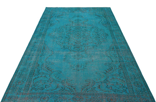 Load image 1 in gallery view. Teal vintage-style rug with a distressed black central medallion and ornate border on a white background.