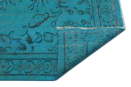 Load image 1 in gallery view. Teal rug with a black traditional floral pattern and a folded corner showing the woven backing.