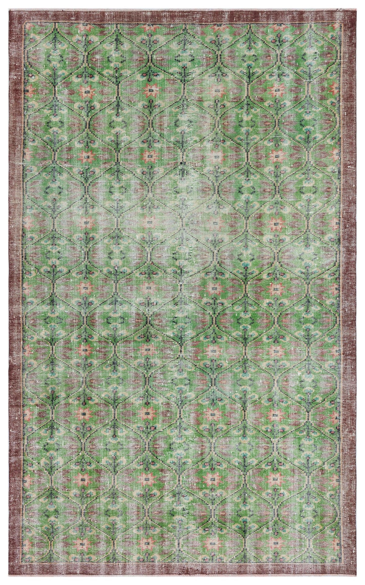 Green and brown distressed rug with a repeating geometric lattice pattern and floral motifs.