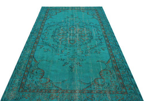 Load image 1 in gallery view. Teal and brown distressed traditional rug with a central floral medallion and ornate border pattern.